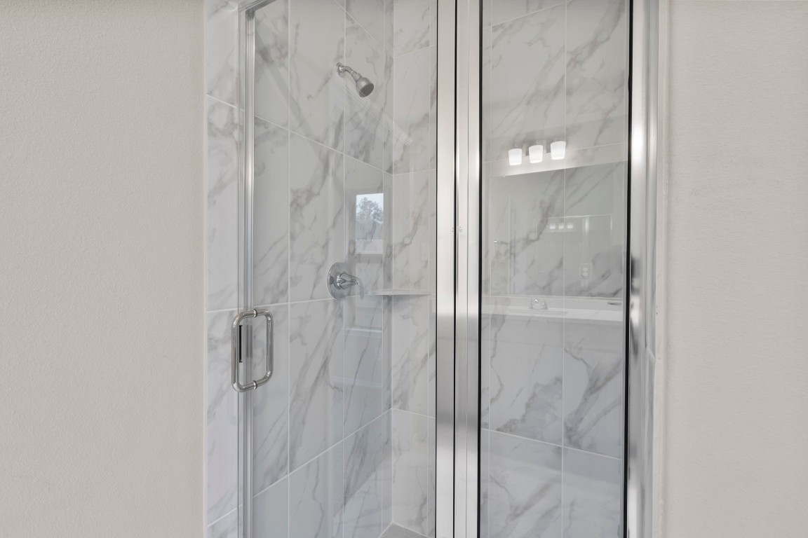 9526 Sierra Crest Lane Porter, TX 77365 - Photo 20 of 39 a bathroom with a glass shower door