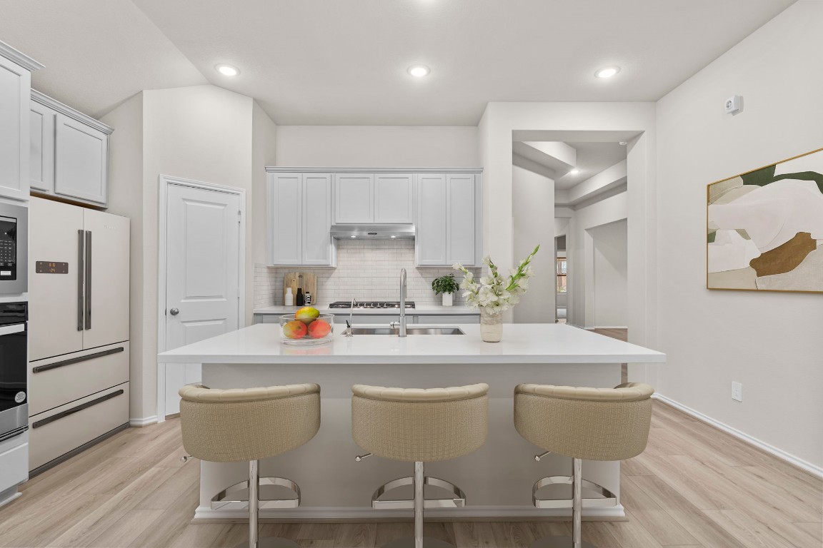 9526 Sierra Crest Lane Porter, TX 77365 - Photo 2 of 39 a kitchen with stainless steel appliances a dining table chairs and white cabinets