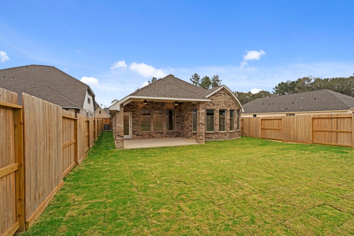 9526 Sierra Crest Lane Porter, TX 77365 - Photo 30 of 39 a front view of a house with garden