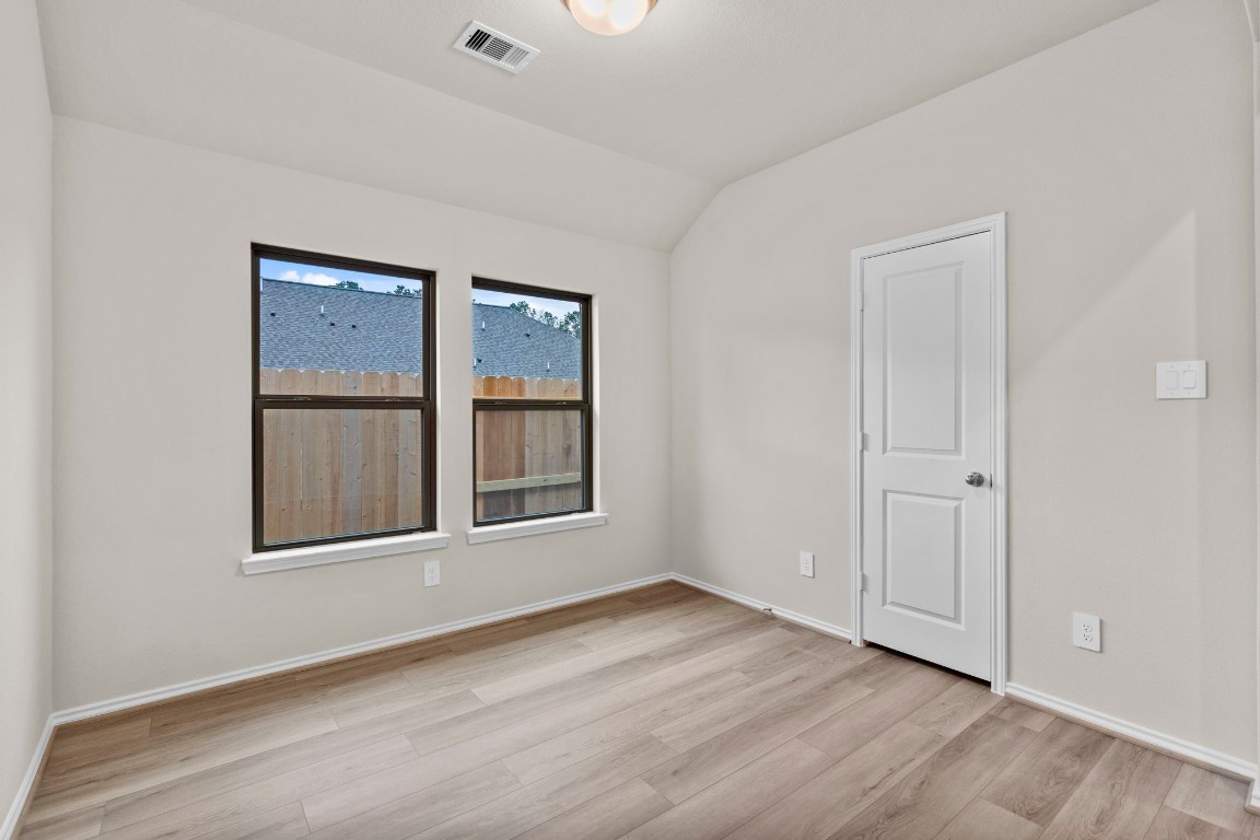 9526 Sierra Crest Lane Porter, TX 77365 - Photo 8 of 39 a view of an empty room with wooden floor and a window