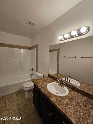 a bathroom with a sink a toilet and bathtub