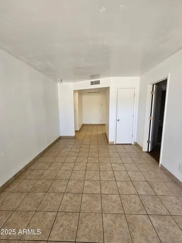 a view of a livingroom with an empty space and a window