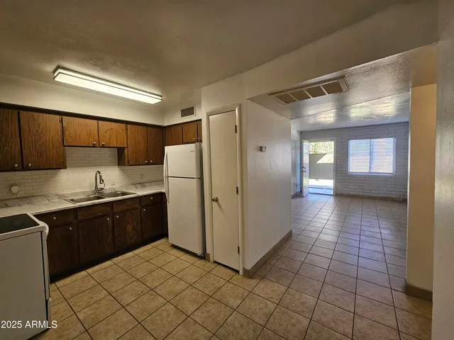 a kitchen with stainless steel appliances granite countertop a refrigerator and a sink