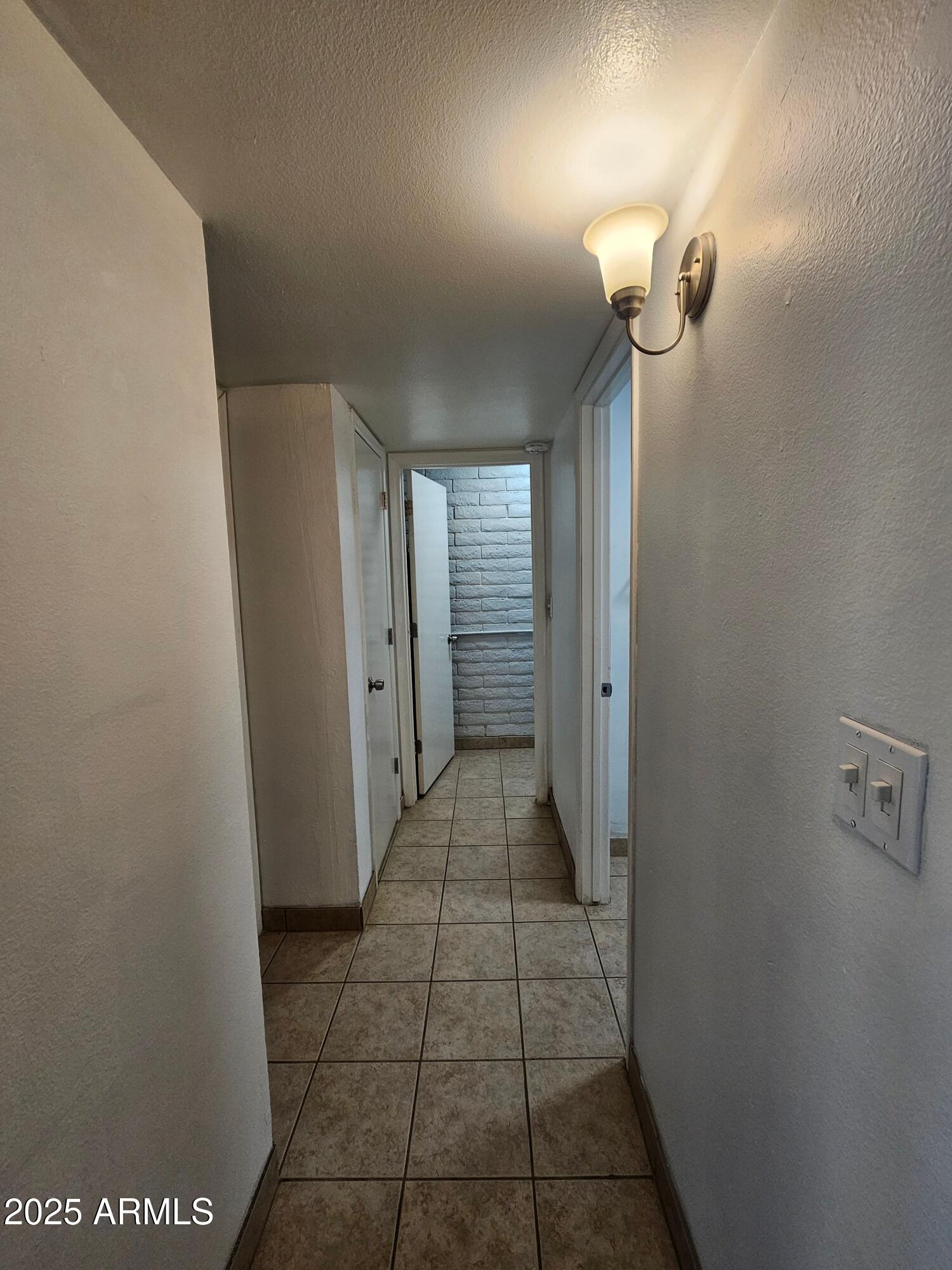 180 North Apache Road, Unit 24 Buckeye, AZ 85326 - Photo 21 of 32 a view of a bathroom from a hallway