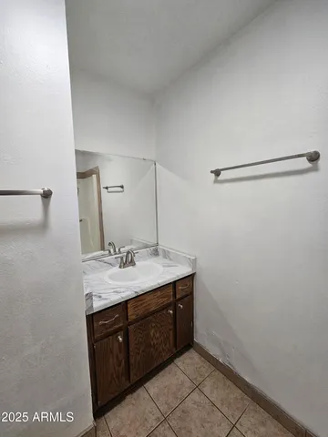 a bathroom with a sink vanity and mirror
