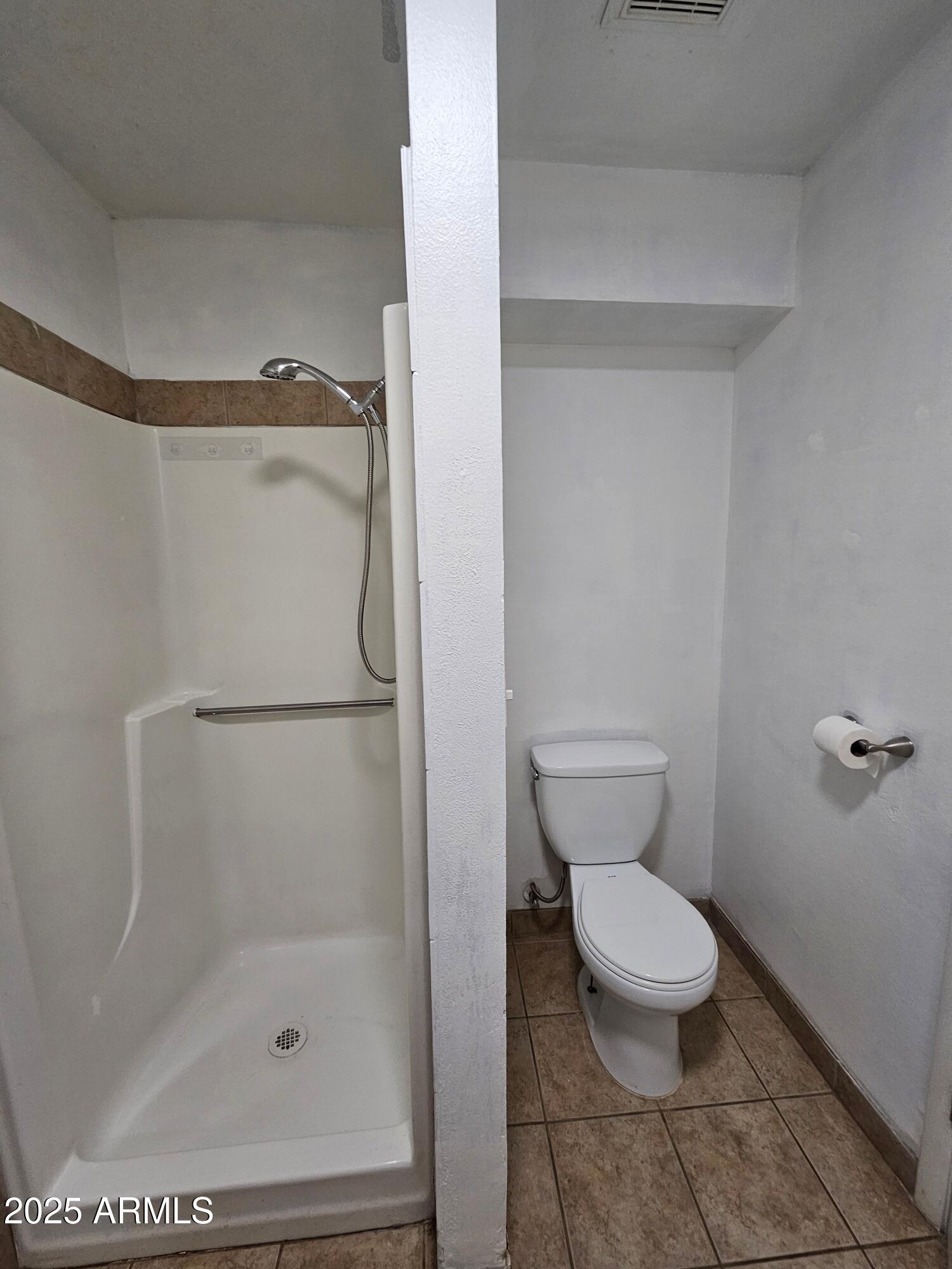 180 North Apache Road, Unit 24 Buckeye, AZ 85326 - Photo 23 of 32 a bathroom with a toilet and a shower