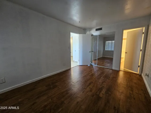 a view of wooden floor and windows in a room