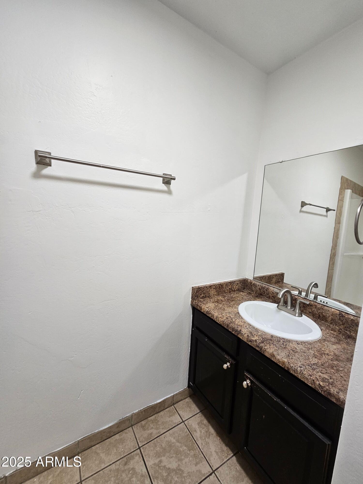 180 North Apache Road, Unit 24 Buckeye, AZ 85326 - Photo 8 of 32 a bathroom with a granite countertop sink and a mirror