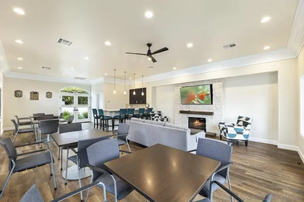 a view of a dining room with furniture a rug and wooden floor