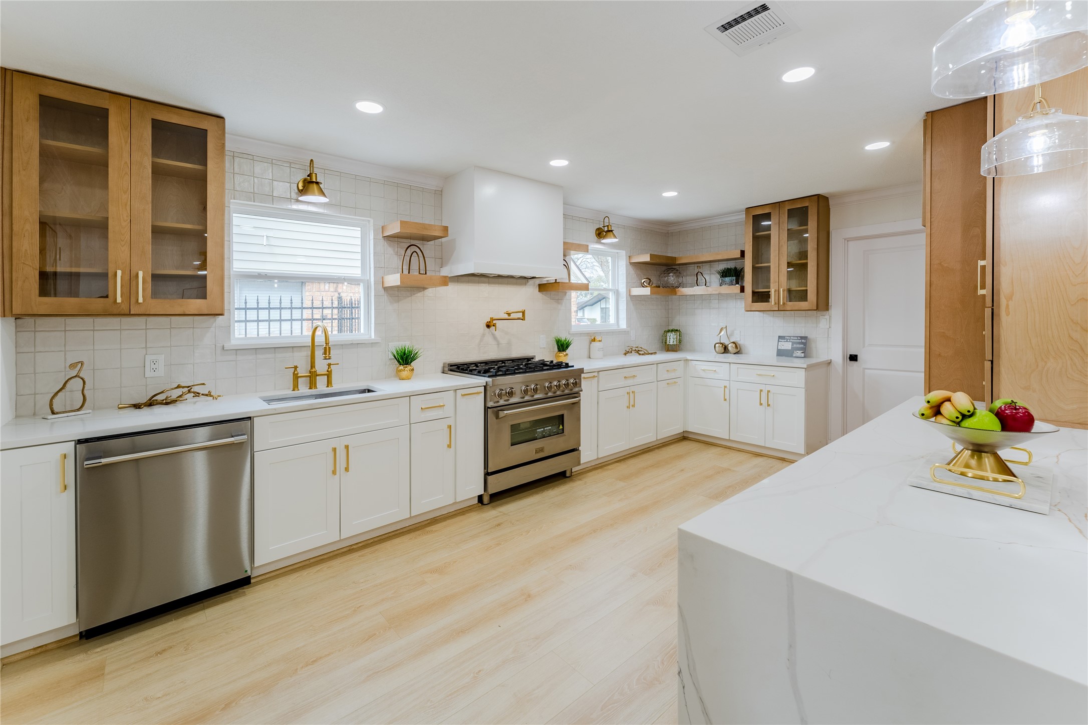 6027 Valkeith Drive Houston, TX 77096 - Photo 2 of 31 a kitchen with a sink white cabinets and white appliances