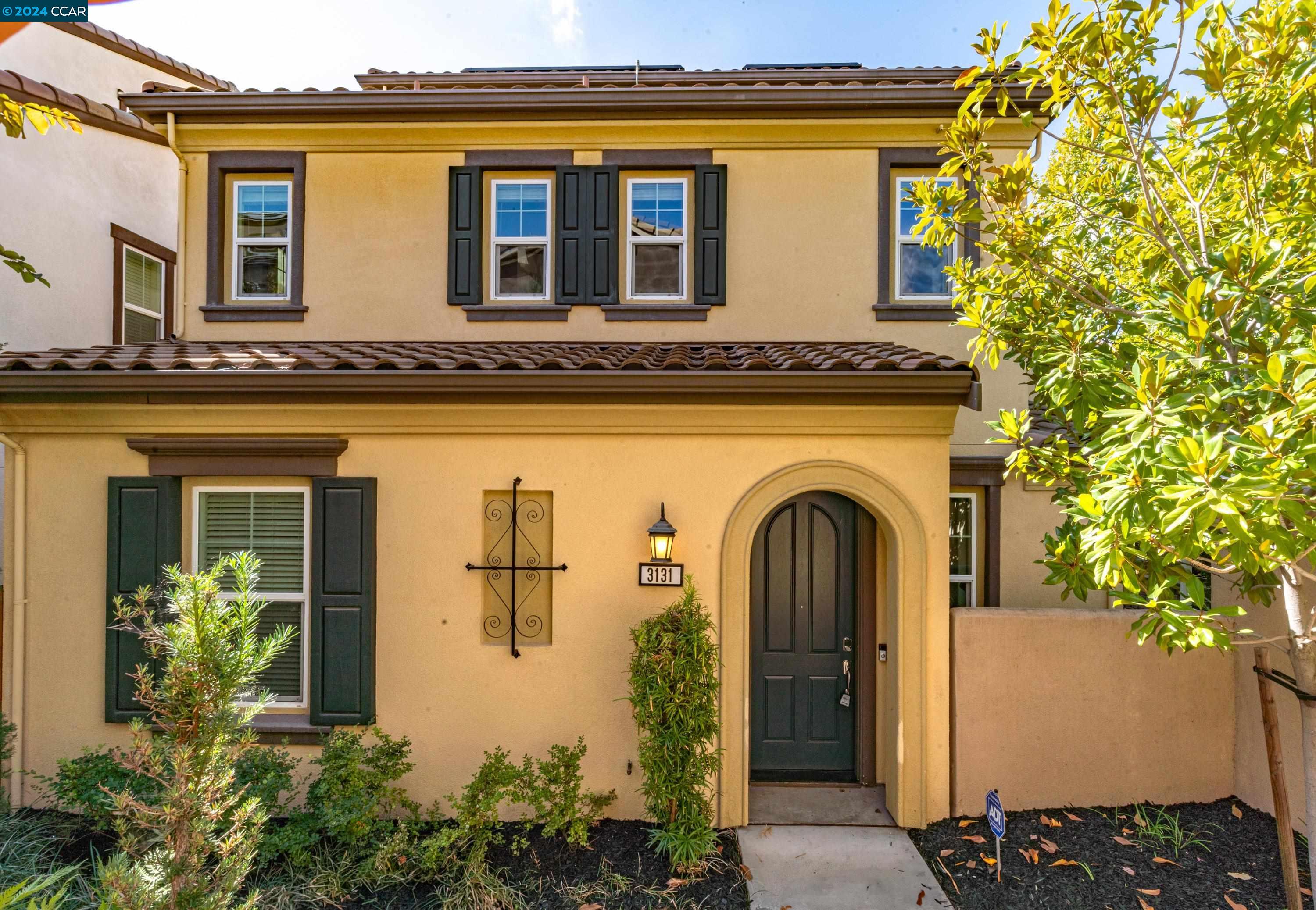 a front view of a house with a garden