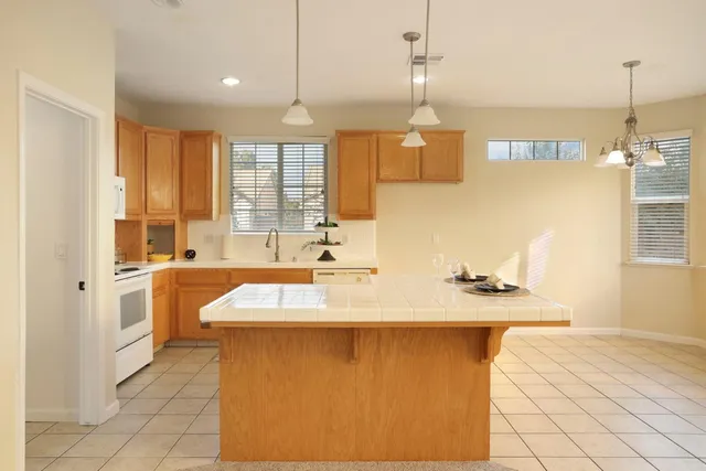 a kitchen with a stove a sink a refrigerator and a microwave