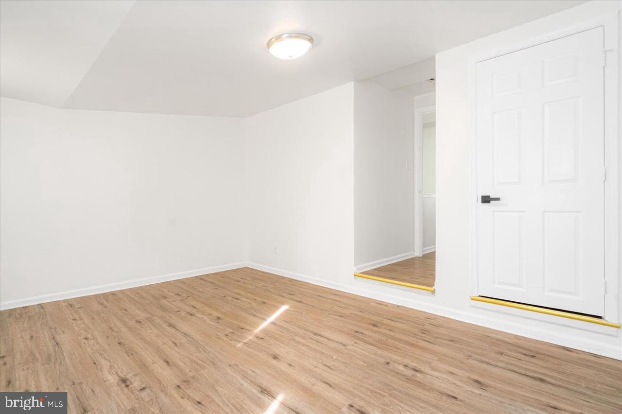 1715 West Lexington Street, Unit 2 Baltimore, MD 21223 - Photo 16 of 21 an empty room with wooden floor