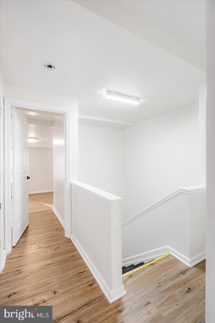 1715 West Lexington Street, Unit 2 Baltimore, MD 21223 - Photo 17 of 21 a view of a hallway with wooden floor