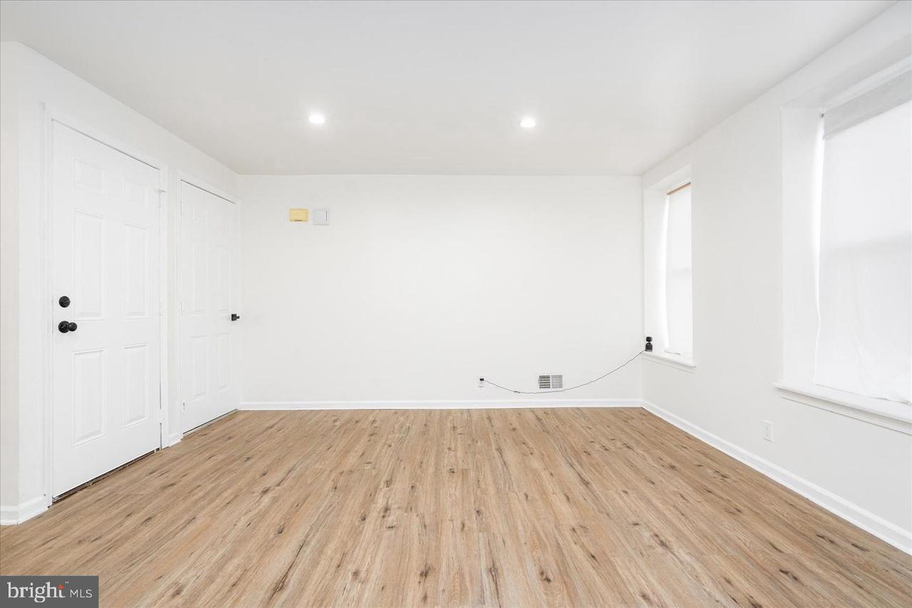 1715 West Lexington Street, Unit 2 Baltimore, MD 21223 - Photo 19 of 21 an empty room with wooden floor