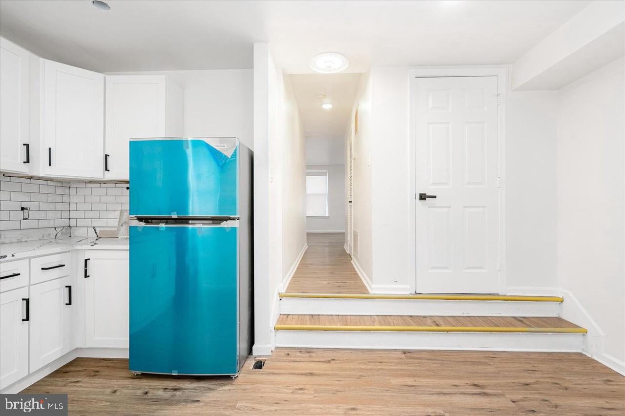 1715 West Lexington Street, Unit 2 Baltimore, MD 21223 - Photo 7 of 21 a kitchen with a refrigerator and cabinets