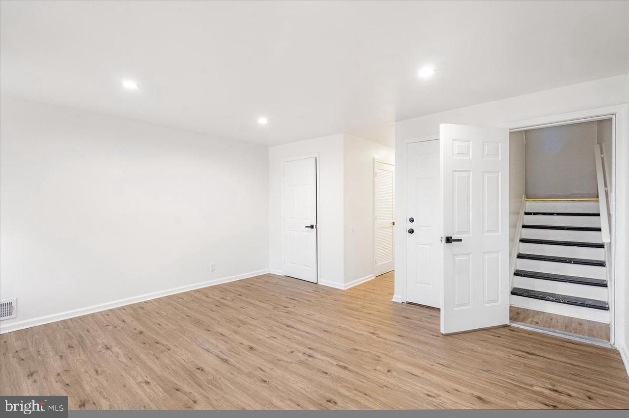 1715 West Lexington Street, Unit 2 Baltimore, MD 21223 - Photo 9 of 21 a view of a room with wooden floor and white walls