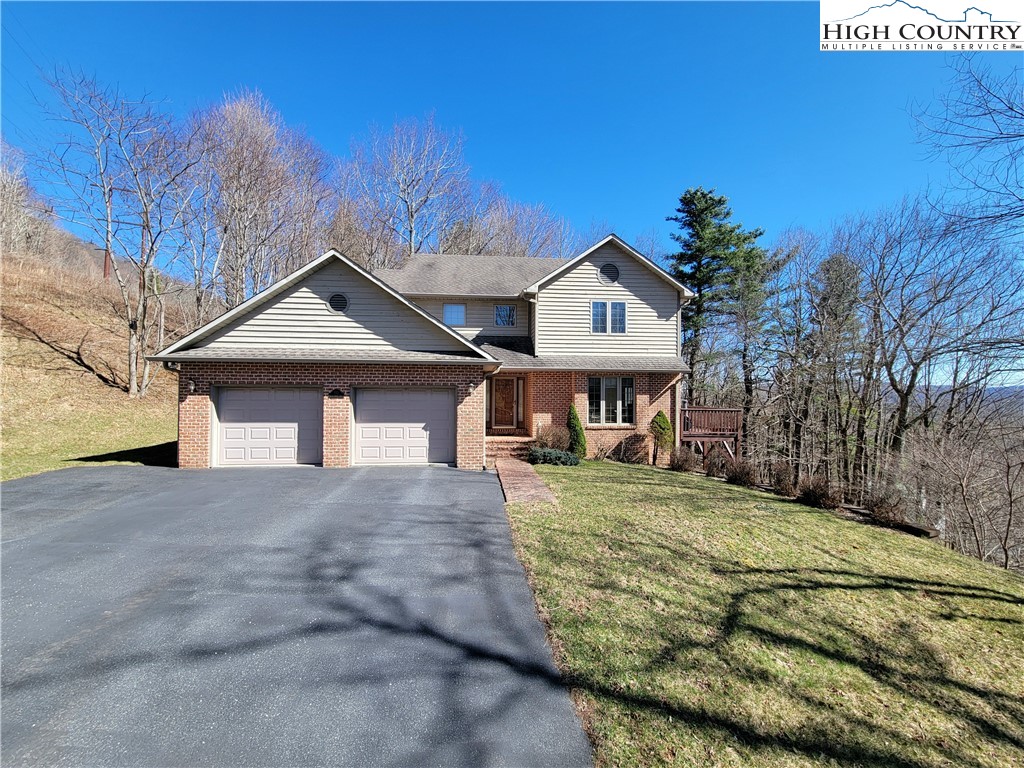 272 Maple Ridge Drive Boone, NC 28607 - Photo 1 of 41 a front view of a house with garden