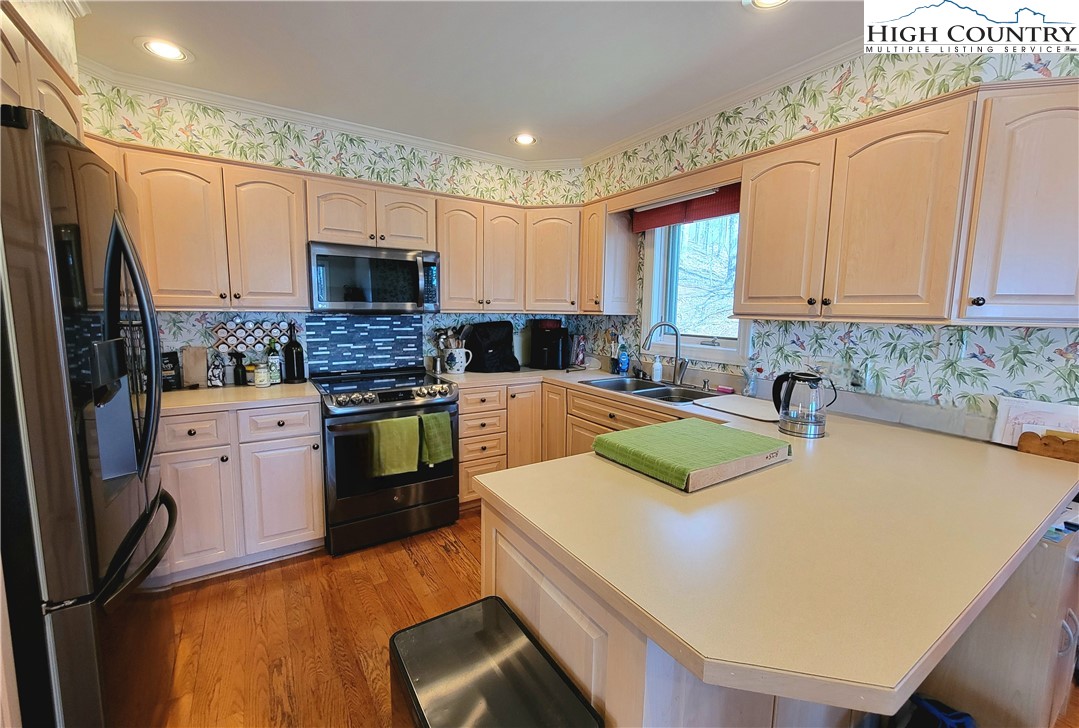 272 Maple Ridge Drive Boone, NC 28607 - Photo 12 of 41 a kitchen with granite countertop a sink stainless steel appliances and cabinets