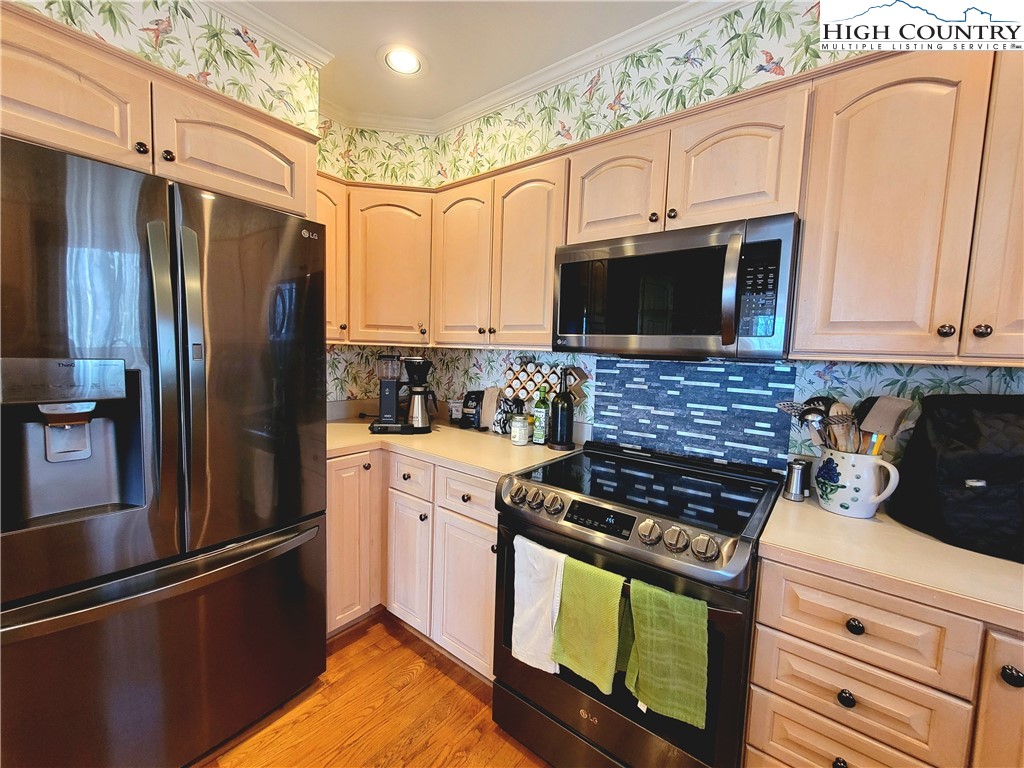 272 Maple Ridge Drive Boone, NC 28607 - Photo 13 of 41 a kitchen with granite countertop a refrigerator stove and microwave