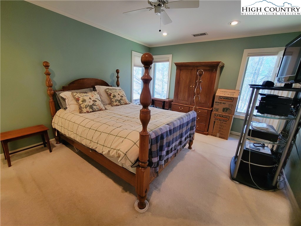 272 Maple Ridge Drive Boone, NC 28607 - Photo 18 of 41 a bedroom with a bed and a gym machine