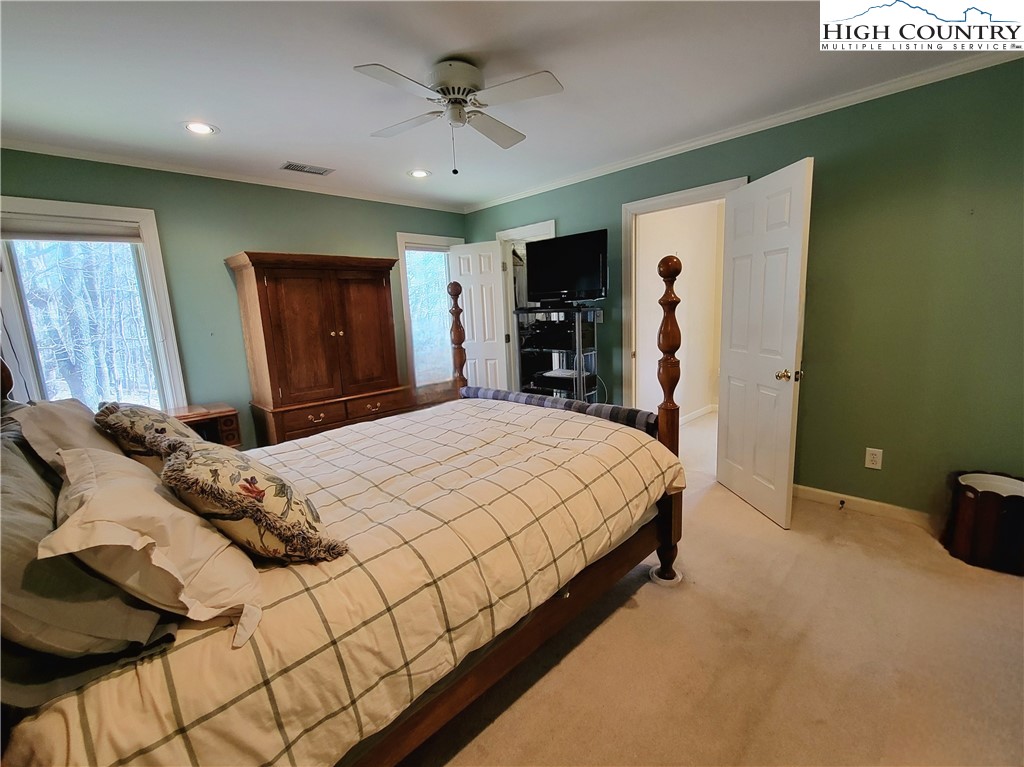 272 Maple Ridge Drive Boone, NC 28607 - Photo 19 of 41 a bedroom with a large bed and a tv
