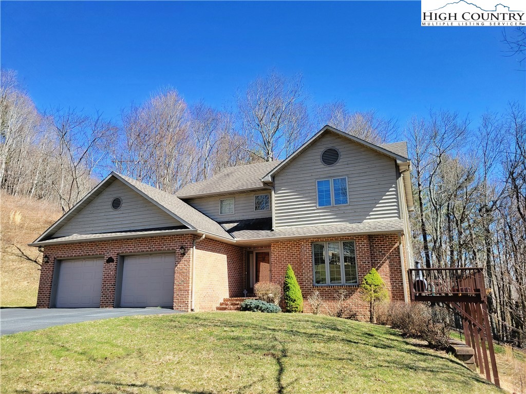 272 Maple Ridge Drive Boone, NC 28607 - Photo 2 of 41 a front view of a house with garden