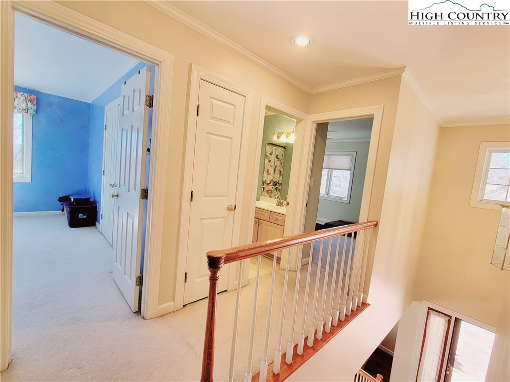 272 Maple Ridge Drive Boone, NC 28607 - Photo 27 of 41 a view of a hallway with wooden floor and windows
