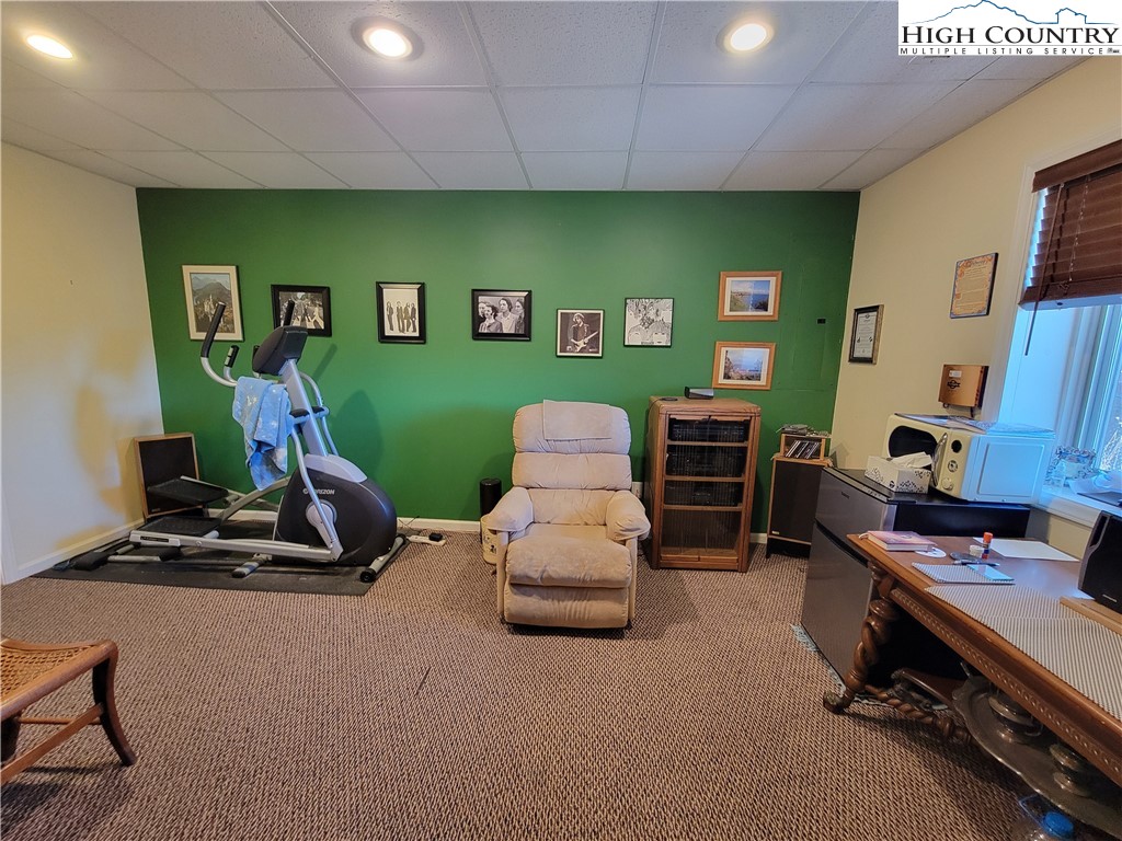 272 Maple Ridge Drive Boone, NC 28607 - Photo 30 of 41 a living room with furniture gym equipment and a flat screen tv