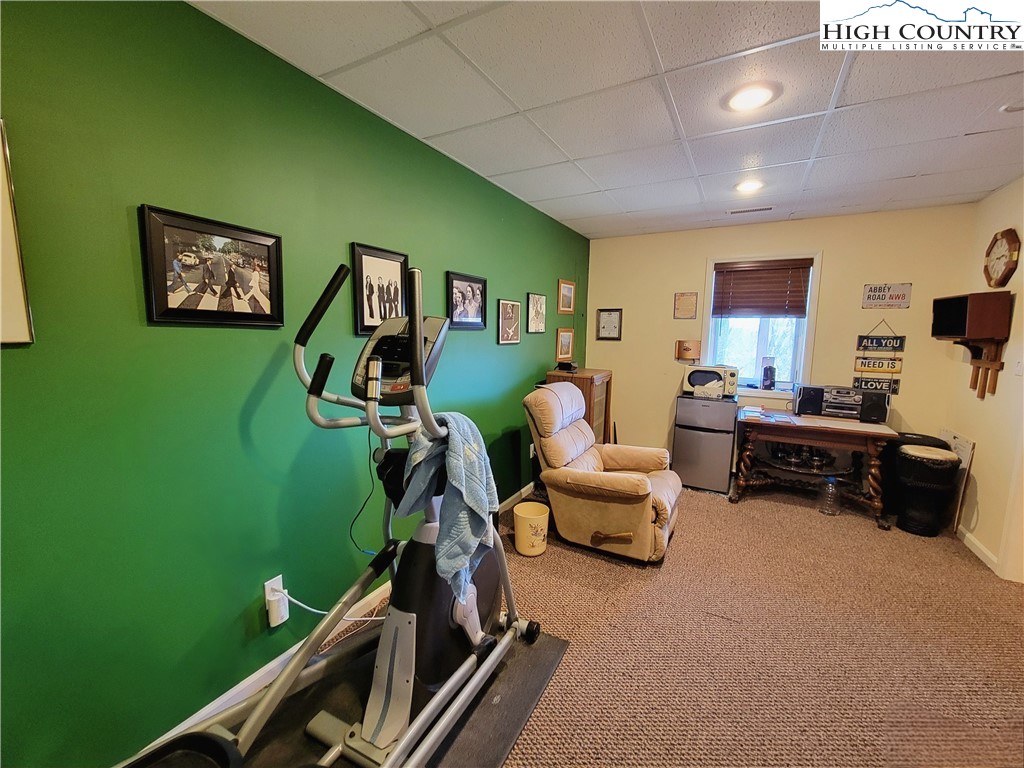 272 Maple Ridge Drive Boone, NC 28607 - Photo 31 of 41 a living room with furniture and a flat screen tv