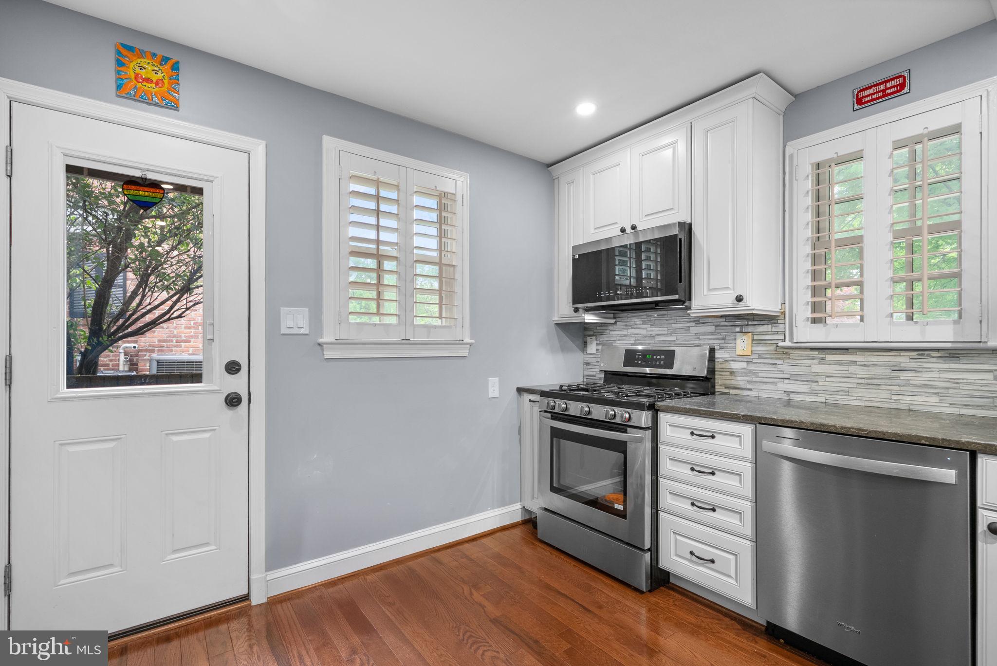 9911 Edgehill Lane Silver Spring, MD 20901 - Photo 11 of 45 a kitchen with stainless steel appliances a stove microwave and sink