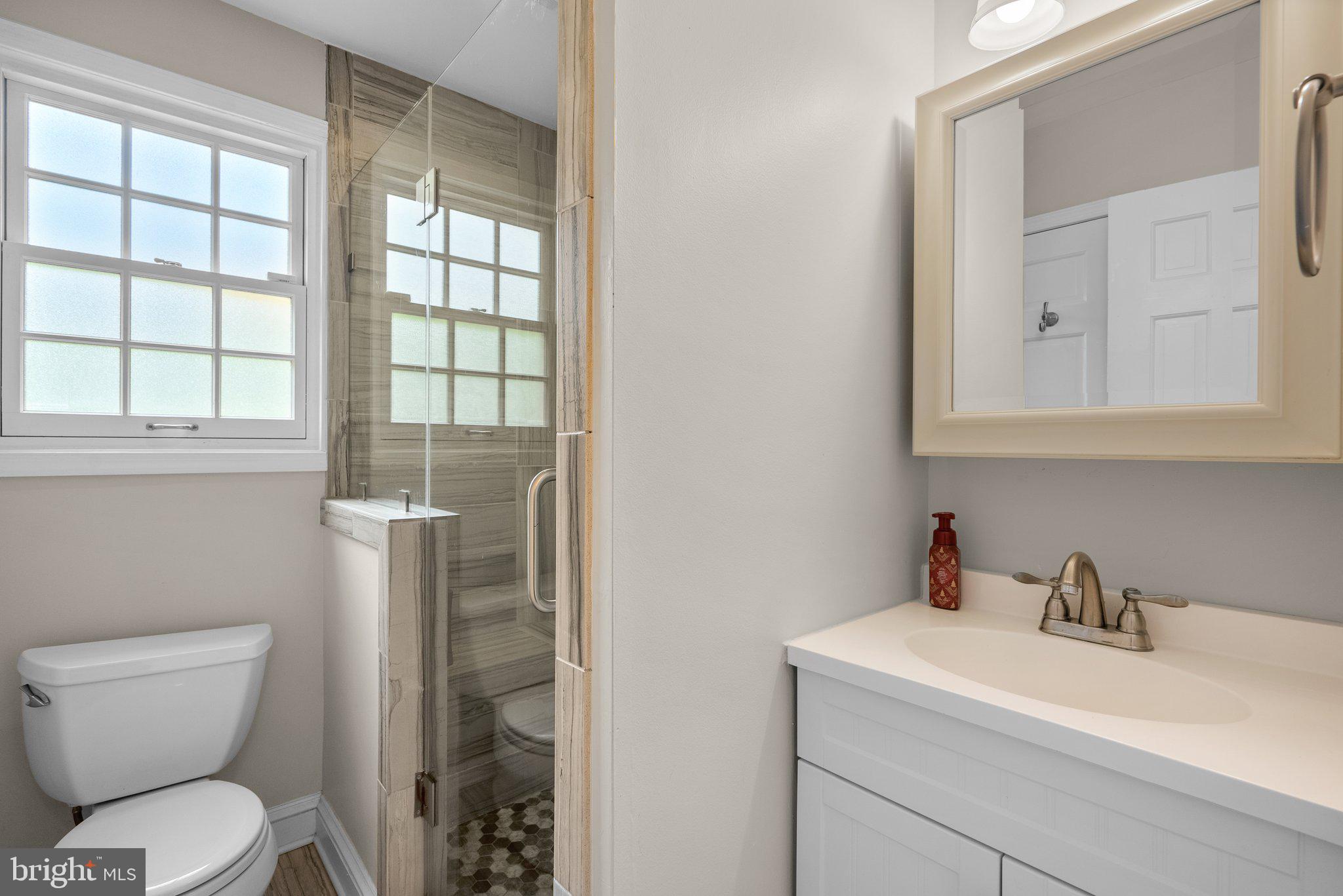 9911 Edgehill Lane Silver Spring, MD 20901 - Photo 14 of 45 a bathroom with a toilet sink vanity and mirror