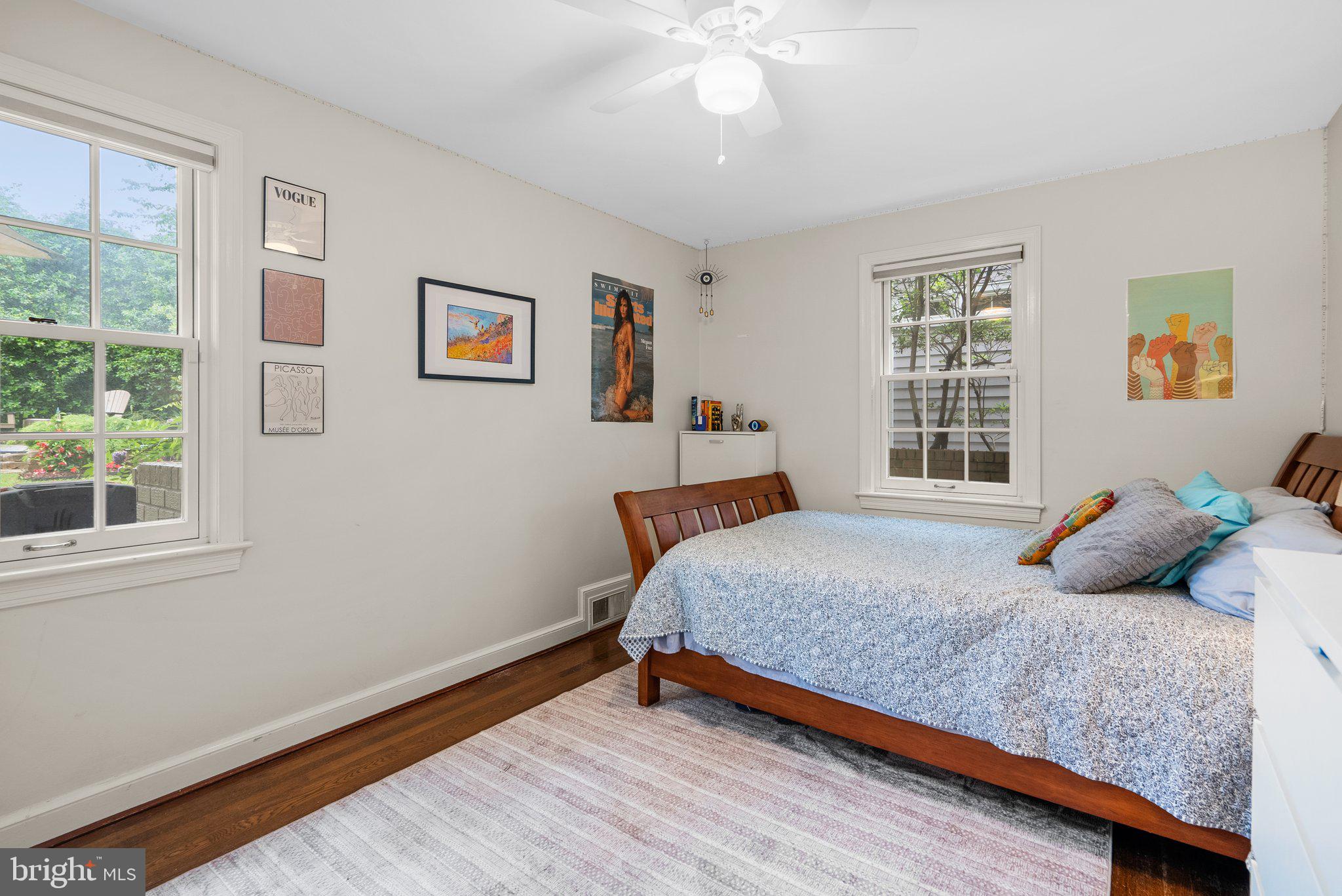 9911 Edgehill Lane Silver Spring, MD 20901 - Photo 15 of 45 a bedroom with a bed and wooden floor