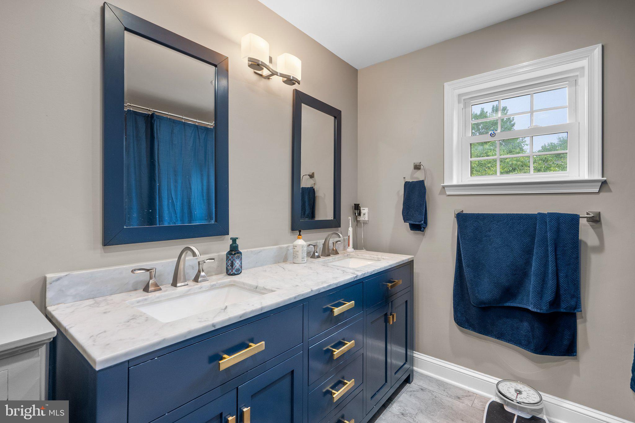 9911 Edgehill Lane Silver Spring, MD 20901 - Photo 25 of 45 a bathroom with a granite countertop sink and a mirror