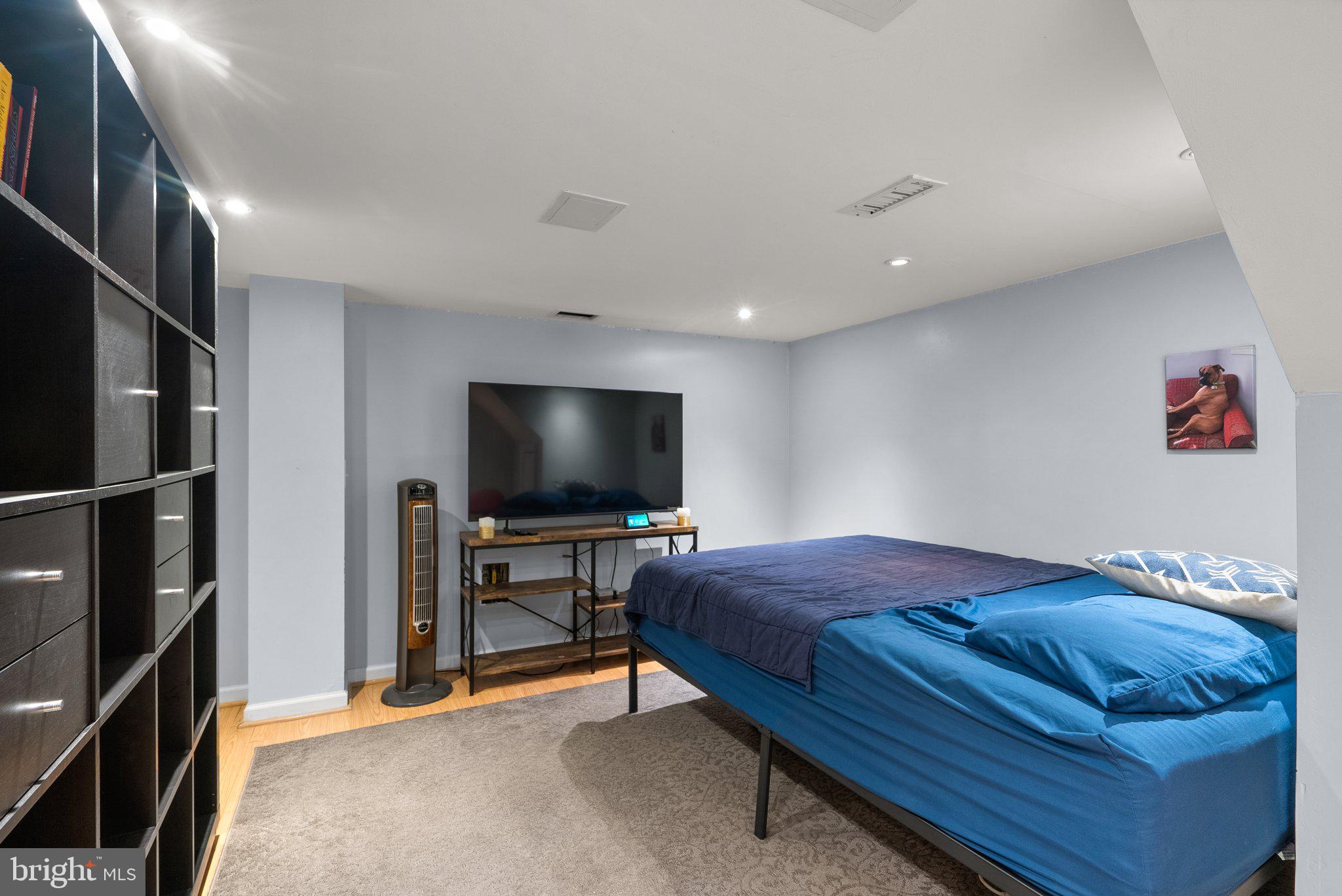 9911 Edgehill Lane Silver Spring, MD 20901 - Photo 31 of 45 a bedroom with a bed and a flat screen tv