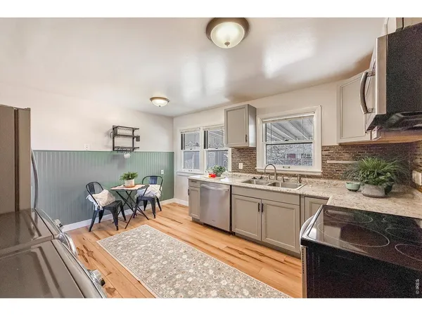 a kitchen with cabinets and wooden floor