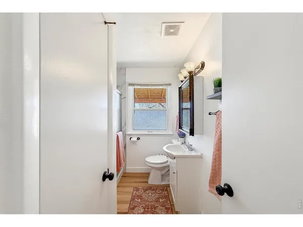a bathroom with a sink toilet and mirror