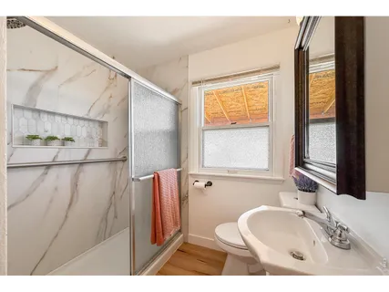 a bathroom with a sink a toilet and a mirror