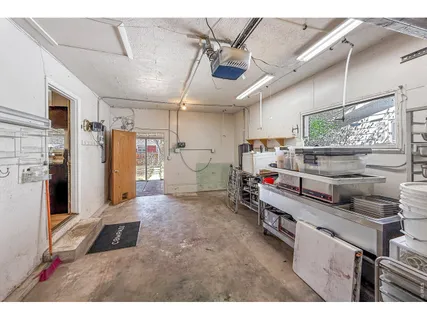 a kitchen with refrigerator and cabinets