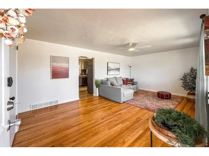 a living room with furniture and flowers