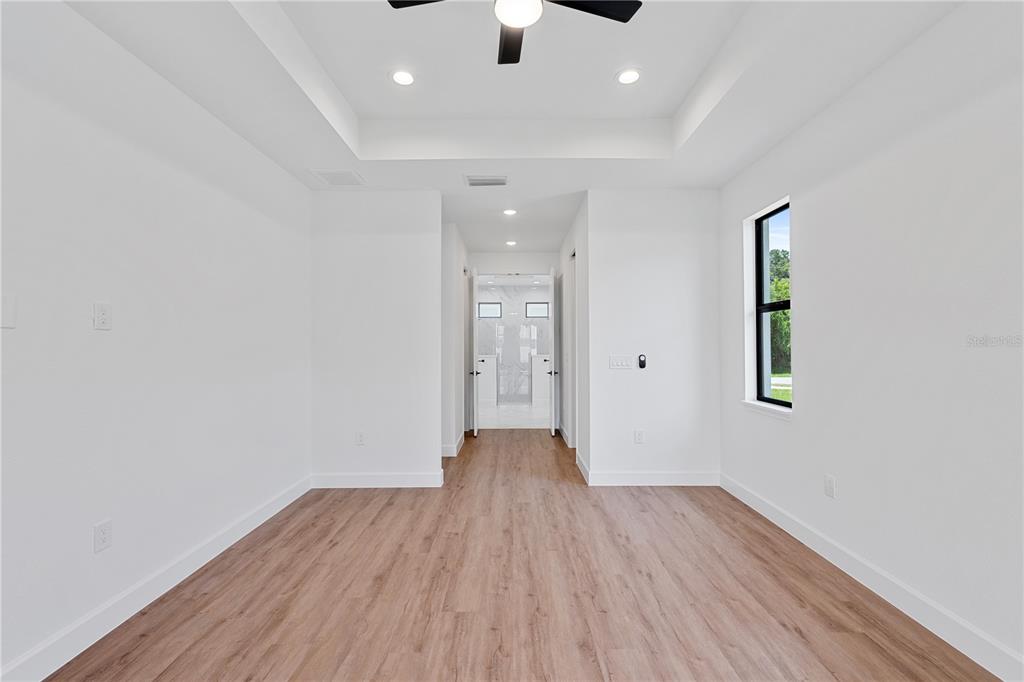 2805 Anniston Road North Port, FL 34288 - Photo 12 of 24 an empty room with wooden floor and windows