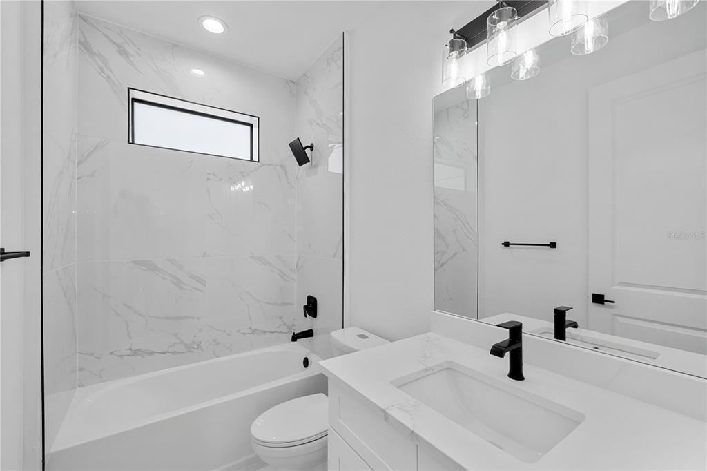 2805 Anniston Road North Port, FL 34288 - Photo 20 of 24 a bathroom with a sink a toilet and shower