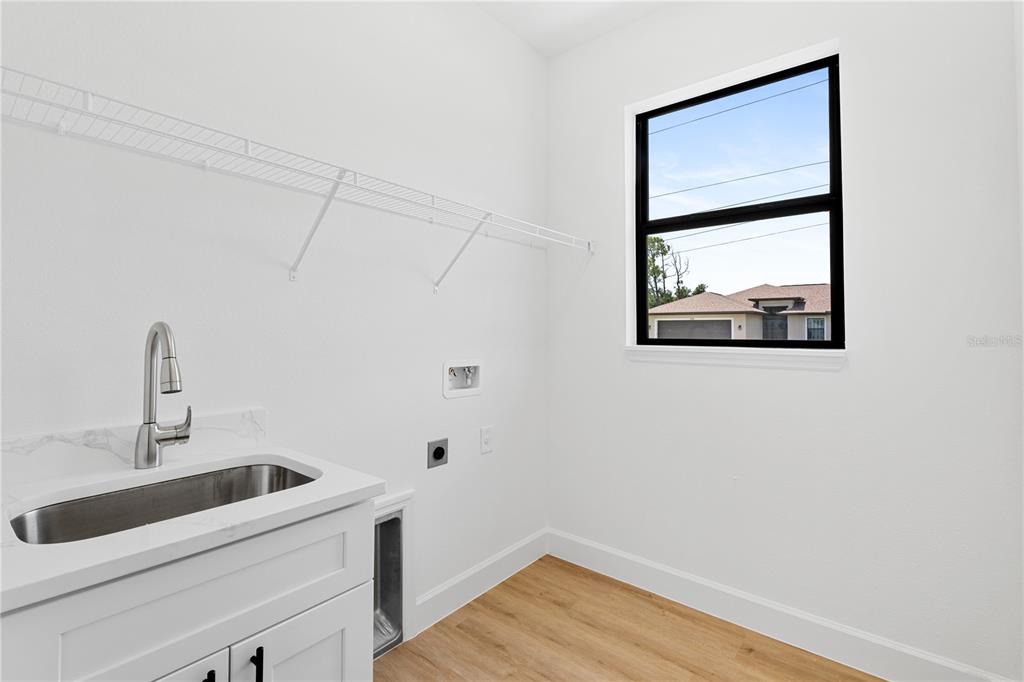 2805 Anniston Road North Port, FL 34288 - Photo 21 of 24 a view of a room that has a sink and wooden floor