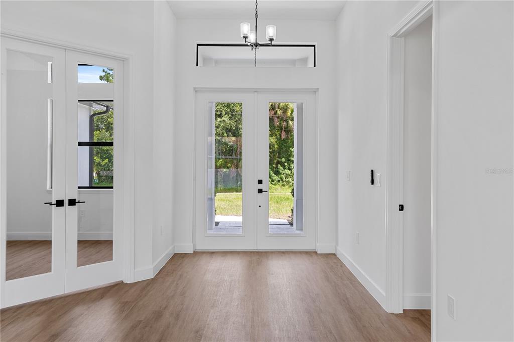 2805 Anniston Road North Port, FL 34288 - Photo 4 of 24 a view of an empty room with window and wooden floor