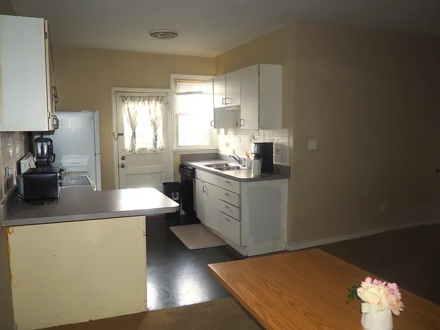 a kitchen with a sink stove and cabinets