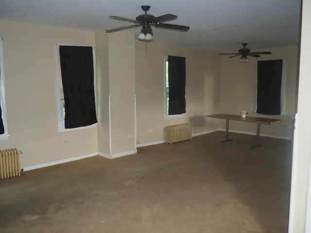 an empty room with windows and closet