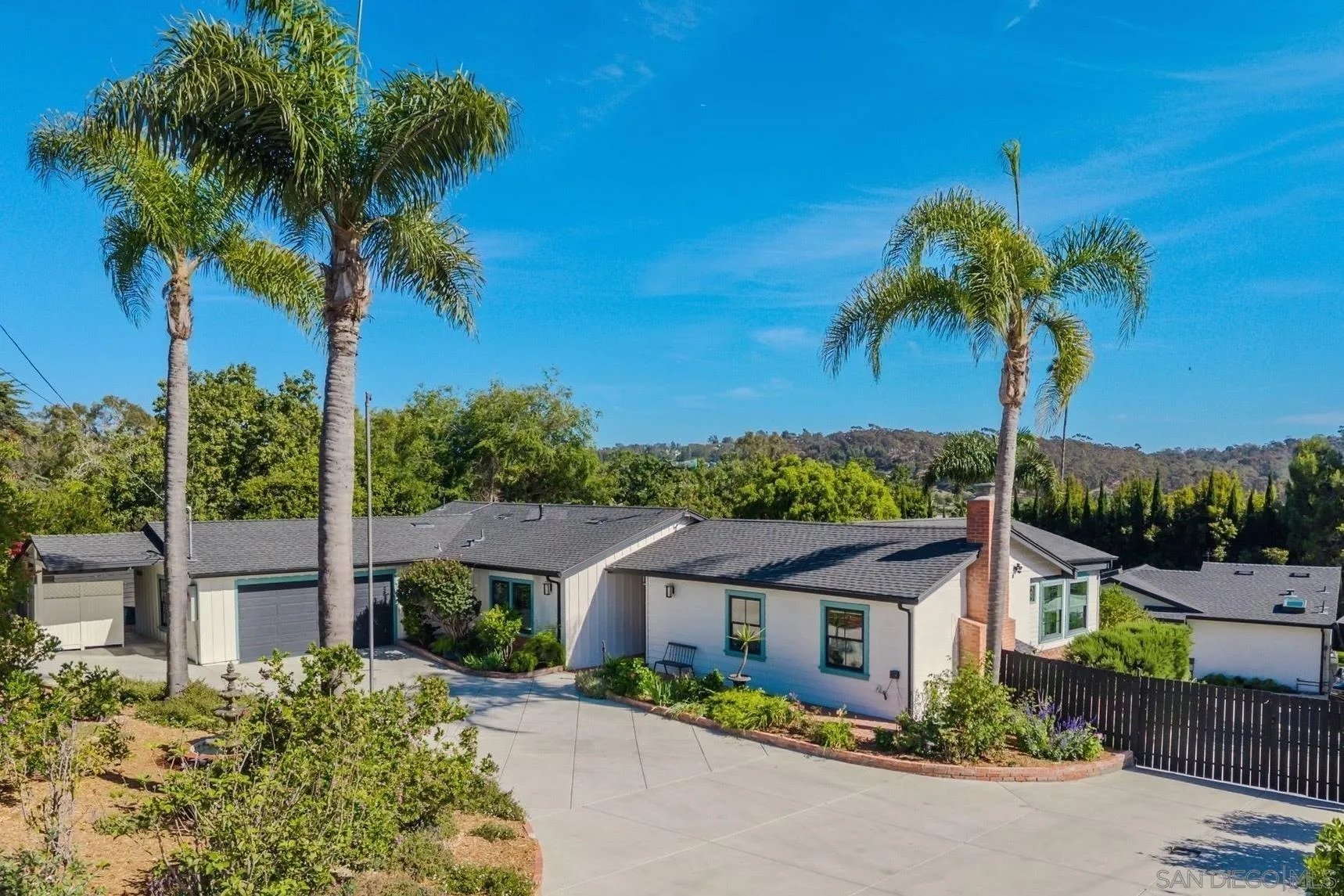 2335 Ivy Road Oceanside, CA 92054 - Photo 7 of 53 a front view of a house with a garden and palm trees