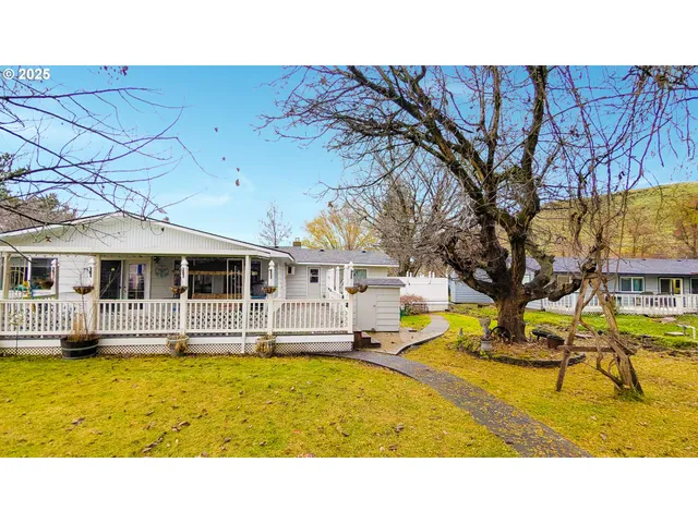 a swimming pool with outdoor seating and yard