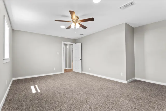 a view of an empty room with a ceiling fan