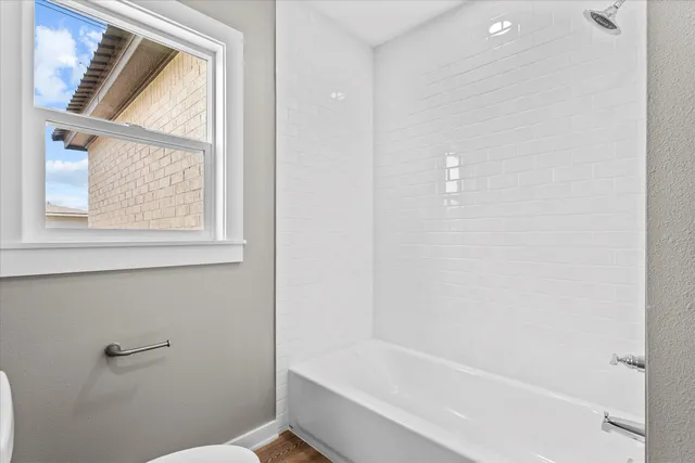 a bathroom with a bathtub and a shower